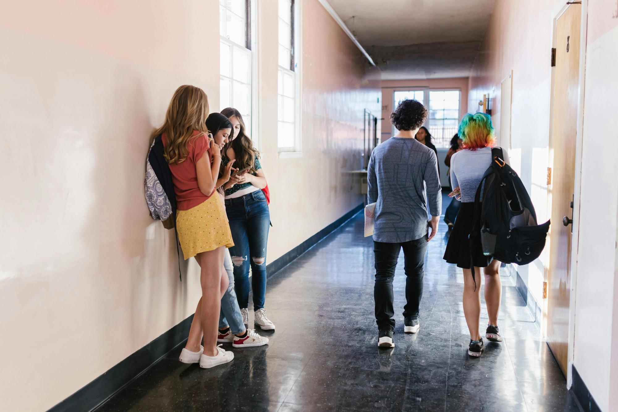 Students on a hallway checking a school timetable