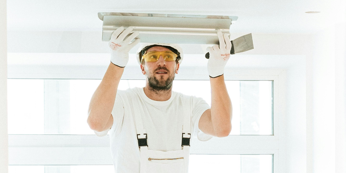 electrican putting light who follows marketing plan for electricians