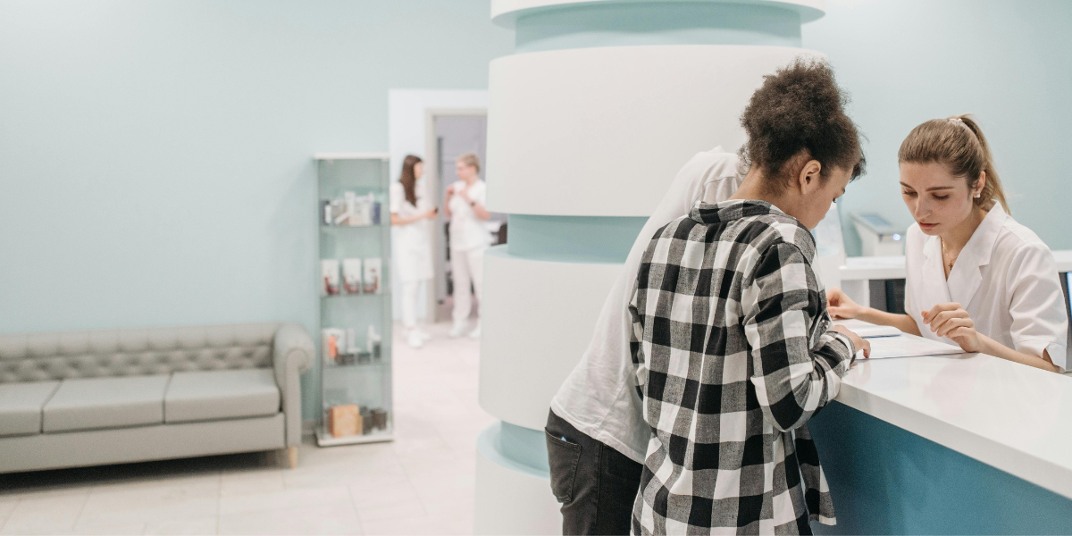 two people standing at the medical clinic registration who used pharmacy scheduling tool for immunization appointment